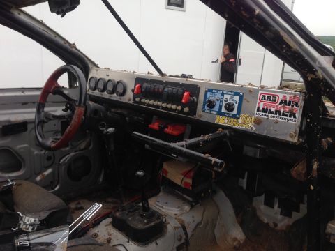 1999 Isuzu Vehicross - The interior of a modified off-road vehicle shows a custom dashboard with multiple switches and gauges, and an ARB Air Locker sticker.