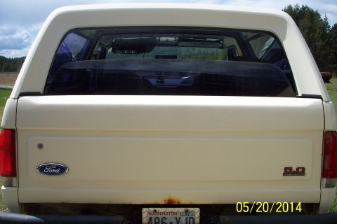 1990 Ford Bronco - Rear view of a white 1990 Ford Bronco, showing the tailgate, Ford emblem, and 5.0 badge.