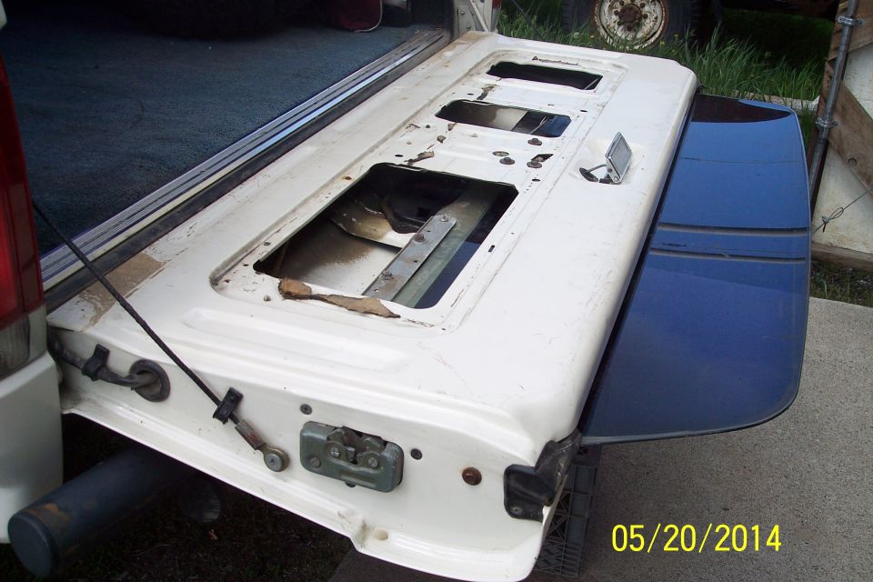 1990 Ford Bronco tailgate removed from vehicle, showing interior mechanism and latch