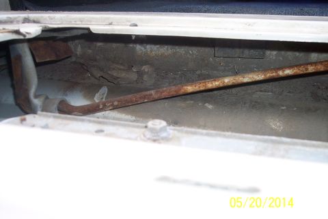 1990 Ford Bronco - Close-up view of the tailgate torsion bar mechanism, showing rust and wear.