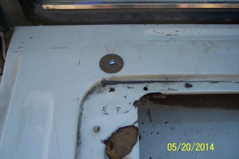 1990 Ford Bronco - Interior view of a tailgate torsion bar mounting area with visible hardware.