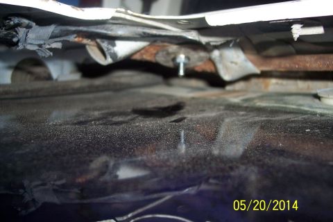 1990 Ford Bronco - Undercarriage view of a vehicle, focusing on the torsion bar mechanism.
