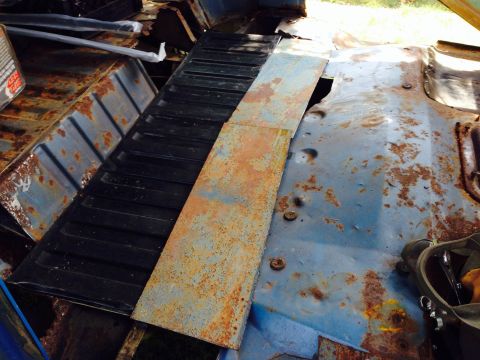 1979 Ford Bronco - The interior floor pan and tailgate of a vehicle show significant rust damage.
