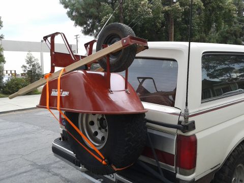 1990 Ford Bronco - A 1990 Ford Bronco is equipped with a spare tire and a wheelbarrow mounted on the rear.