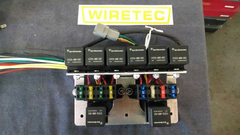 1968 Ford Mustang - A WireTec branded relay and fuse box assembly is shown, six automotive relays and several color-coded fuses.