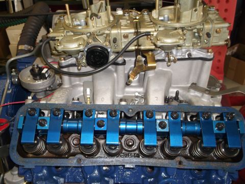 1967 Ford Mustang - Close-up view of a V8 engine dual carburetors and bright blue valve covers.