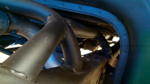 1967 Ford F-250 - The underside of a vehicle, focusing on the frame and suspension assembly with visible metalwork.