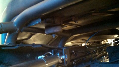 1967 Ford F-250 - Close-up of the undercarriage, showing exhaust manifold and structural elements.