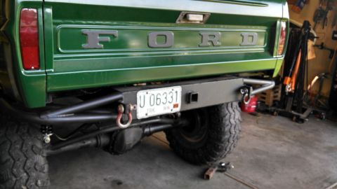 1967 Ford F-250 - Rear view of a green Ford truck a custom bumper, tow hooks, and a license plate.