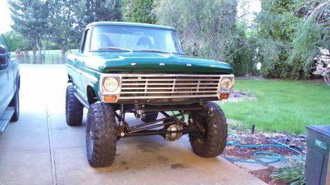 1967 Ford F-250 - This lifted 1967 Ford F-250 pickup truck is presented in a front-facing view, its modified suspension and off-road tires.