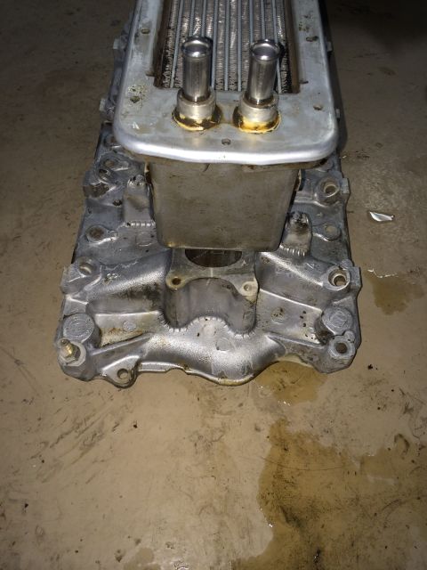 1996 Ford Bronco - This is a supercharger part, likely from an older vehicle, with visible metal tubes and a silver casing.