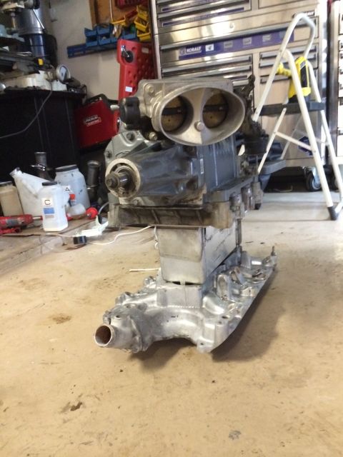 1996 Ford Bronco - Engine with supercharger assembly on a stand in a workshop environment.