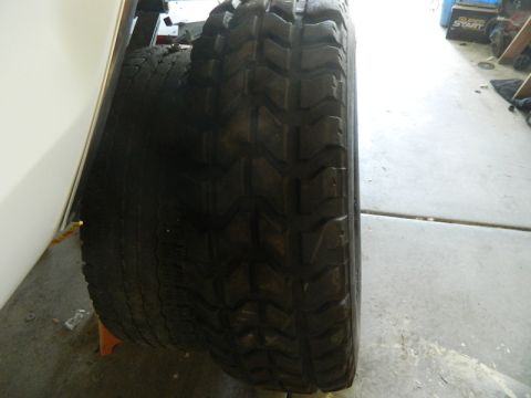 1979 Ford Bronco - A close-up view focuses on the aggressive tread pattern of a large off-road tire.
