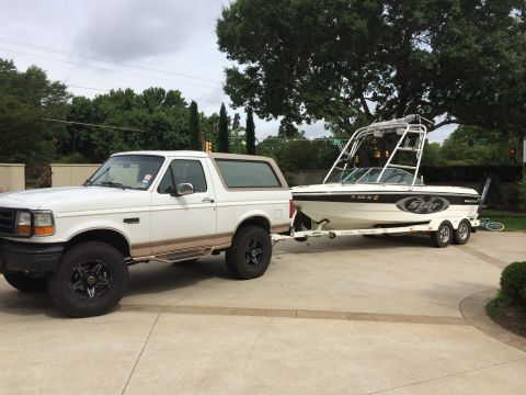 1996 Ford Bronco - 1992 Ford Bronco is seen towing a boat on a trailer.