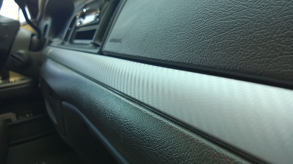 Interior dashboard trim with carbon fiber pattern