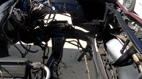 1972 Ford Ranchero - Disassembled vehicle chassis with visible engine components and wiring harness.