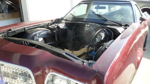 1972 Ford Ranchero - The engine bay of a 1972 Ford Ranchero is shown with the engine removed.