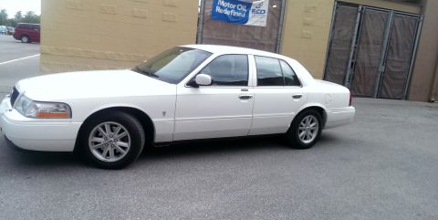 2000 Mercury Grand Marquis - Side view of a white 2000 Mercury Grand Marquis sedan parked outdoors.