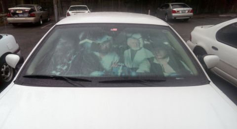 2000 Mercury Grand Marquis - Star Wars characters are displayed on the dashboard of a white sedan parked in a lot.
