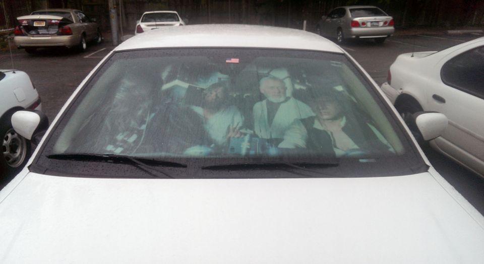 Star Wars characters on dashboard of a white car