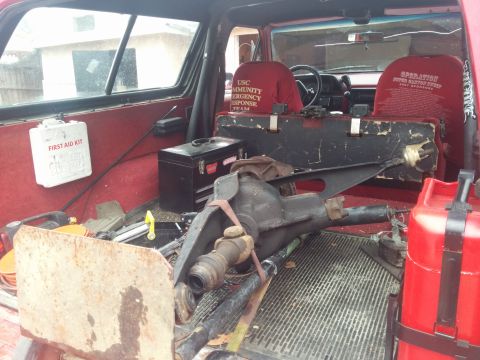1988 Ford Bronco - Loaded interior of a 1988 Ford Bronco, showing a differential and emergency response team gear.