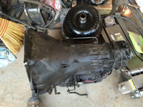 1991 Ford F-250 - An automatic transmission and its torque converter are shown disassembled, likely for repair or replacement.