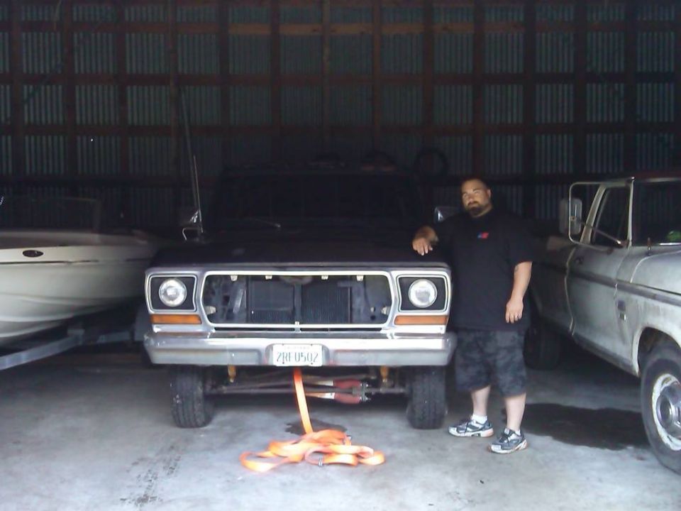 Front view of a 1978 Ford Bronco with a man beside it. License plate reads 2JB 0502