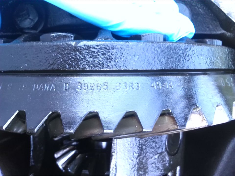 Close-up of differential gears with DANA D 39265 33R3 49-14 stamped on housing