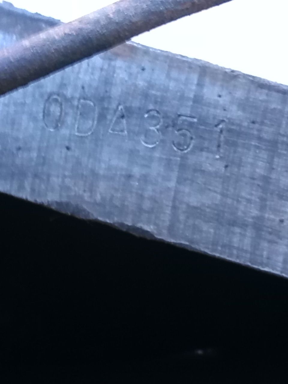 Stamped metal part with numbers 0DA351