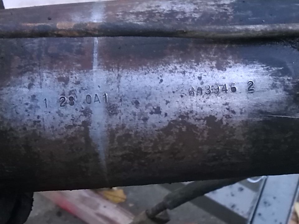 Close-up of a metal part with stamped numbers: 1 28 OA1 and 6A3946 2