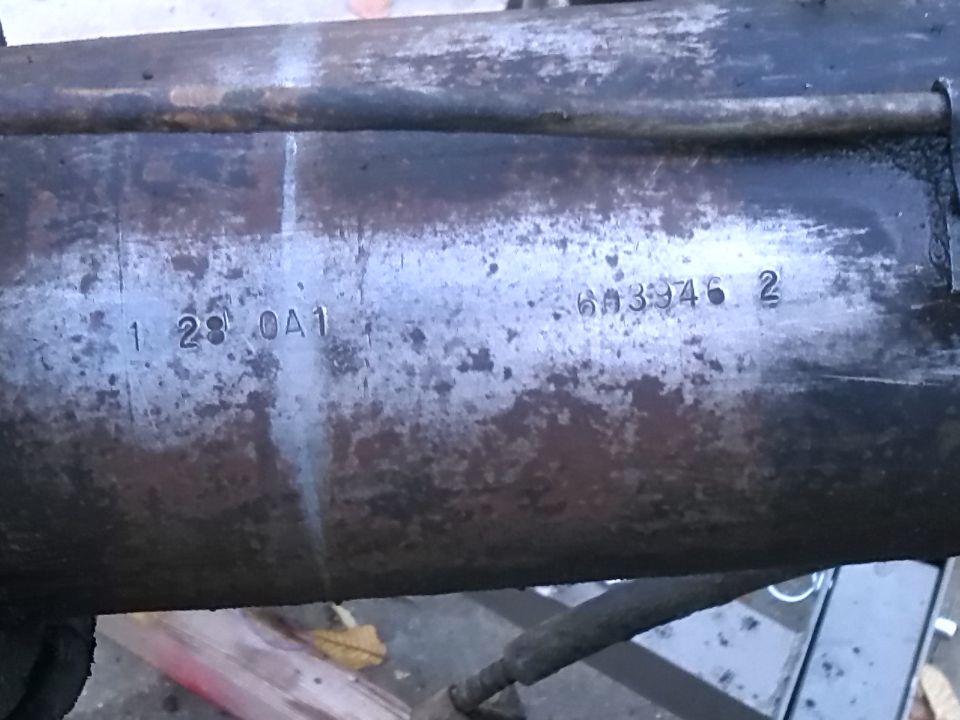 Close-up of a metal part with stamped numbers 1 23 0A1 and 613346 2