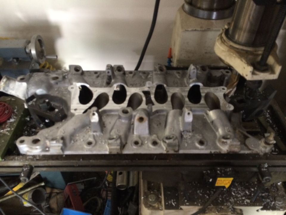 Aluminum intake manifold being machined on a milling machine