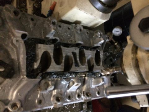 1996 Ford Bronco - Machining an engine block with metal shavings and a pressure gauge in view.