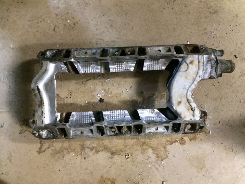 supercharger intake manifold with internal fins and mounting holes