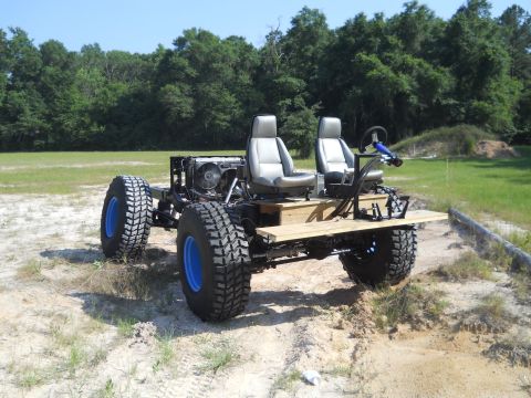 1992 Ford Bronco - This custom-built vehicle appears to be a modified chassis with a rudimentary seating arrangement and exposed mechanical components.