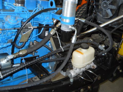 1992 Ford Bronco - Detail of engine components including hoses, filter, and brake master cylinder.