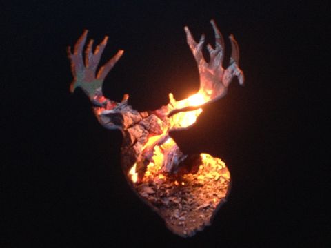 1978 Ford Bronco - A silhouette of a deer's head is illuminated from within by a fiery glow of burning wood.