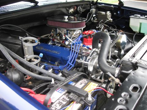 1982 Ford Bronco - Close-up of a modified Ford engine bay blue valve covers and chrome components.