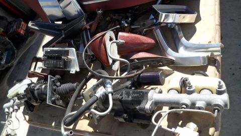 1972 Ford Ranchero - A collection of disassembled vehicle components are laid out on a surface.
