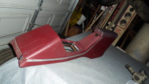 1972 Ford Ranchero - A red center console with chrome trim is shown, likely a car part.