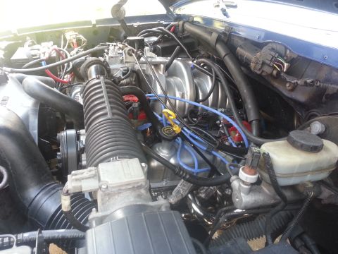1994 Ford Bronco - Close-up view of a vehicle's engine compartment, showing various components and wiring.