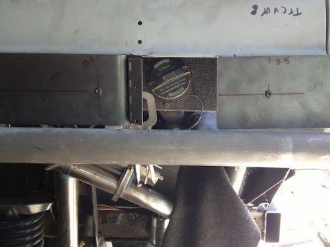 1961 International Scout 800 - Close-up of a vehicle's fuel filler cap and surrounding chassis components.