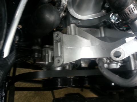 1994 Ford Bronco - Close-up view of an engine's belt and pulley system, showing mechanical components.