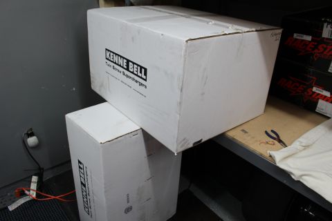2003 Ford Crown Victoria - White cardboard boxes labeled Kenne Bell Superchargers stacked on a shelf in a garage with Race Star boxes behind.