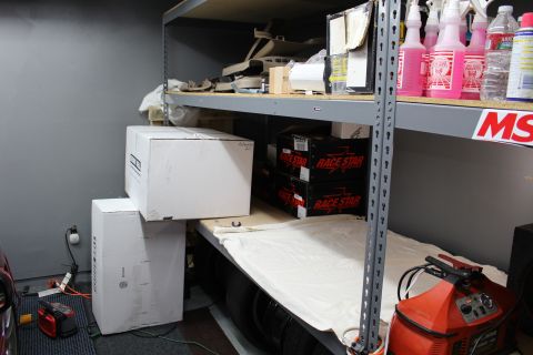 2003 Ford Crown Victoria - White cardboard boxes and Race Star boxes on a garage shelf, with pink spray bottles and an MSD label nearby.
