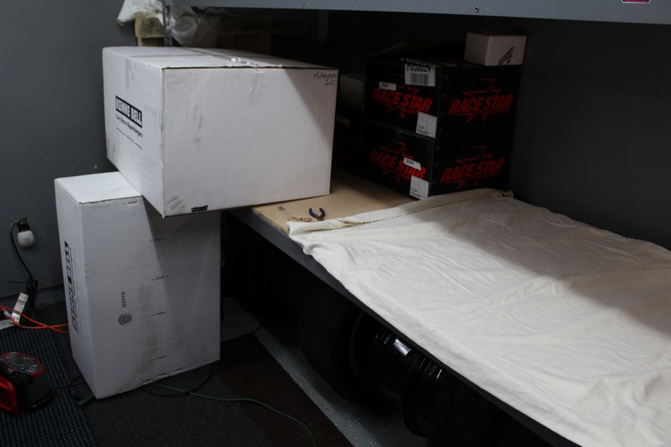 White cardboard boxes on a draped shelf next to Race Star boxes
