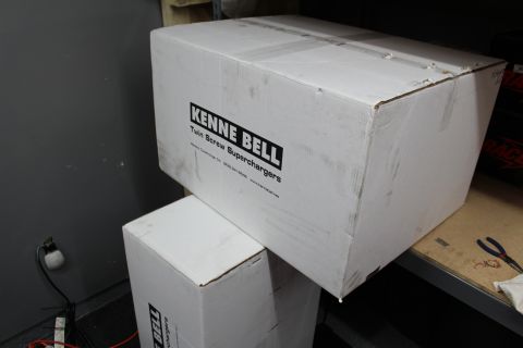 2003 Ford Crown Victoria - large white box labeled Kenne Bell Twin Screw Superchargers stacked on a garage shelf.