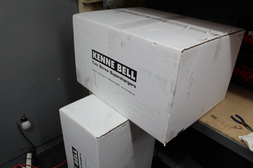 Large white Kenne Bell Twin Screw Superchargers box on a garage shelf