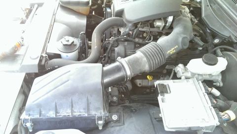 2000 Mercury Grand Marquis - Engine bay of a 2000 Mercury Grand Marquis, with visible air intake system and brake fluid reservoir.