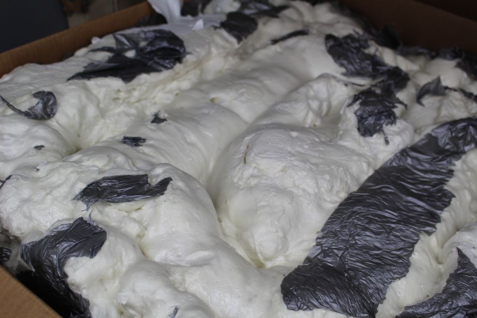 Close view of white packing foam ridges with dark plastic woven through